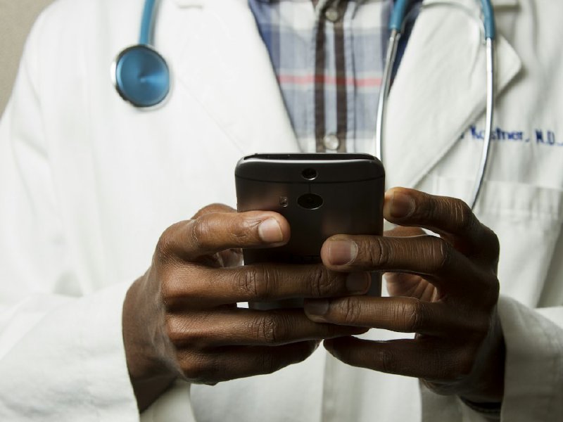 Clinician reviewing notes between patient visits